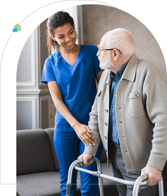 A nurse and an elderly man with walking frame.